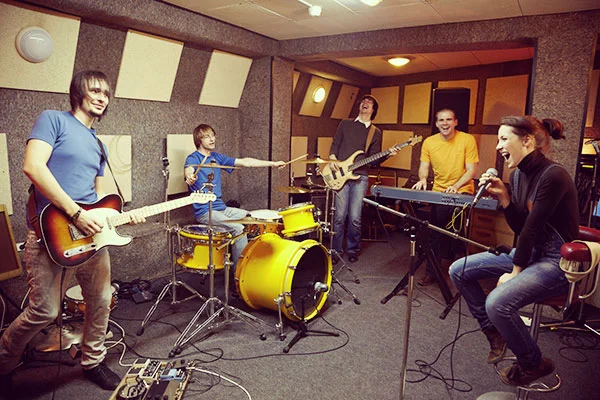 Band rehearsing together in a studio, illustrating the Voxly Vision team hiring a full stack AI software engineer