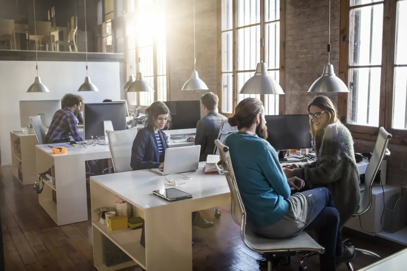 Team in a sunlit open-plan office reviewing financial promotions against the FCA rules