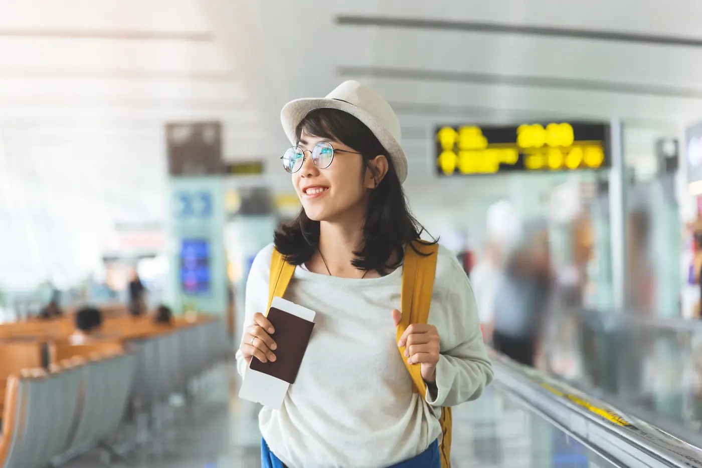 Smiling traveller holding a passport, the kind of buy now, pay later ad Voxly Vision checks against CONC 3