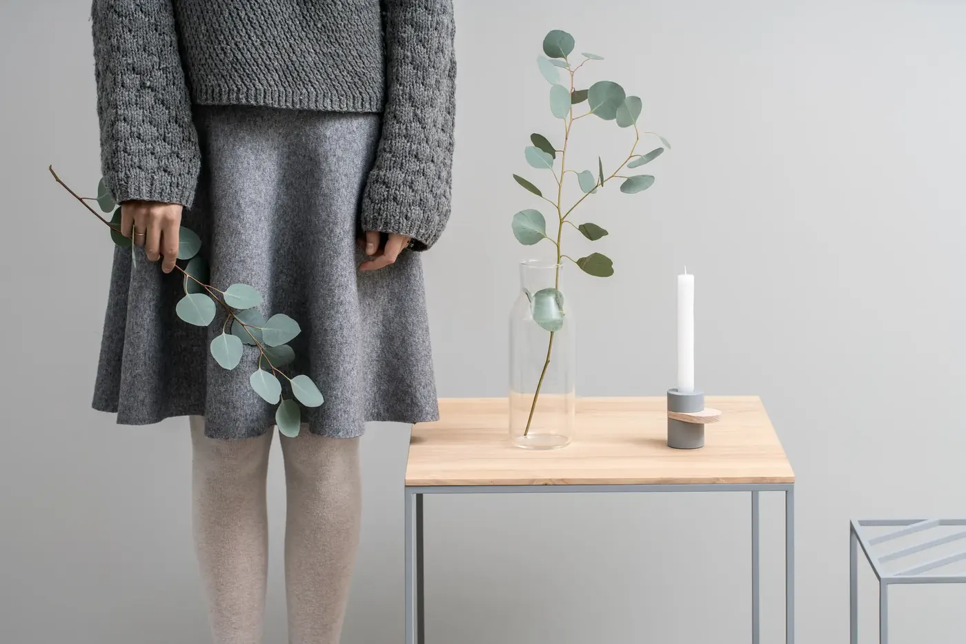 Woman holding eucalyptus in a calm interior, typical wellness ad imagery checked against the MHRA Blue Guide