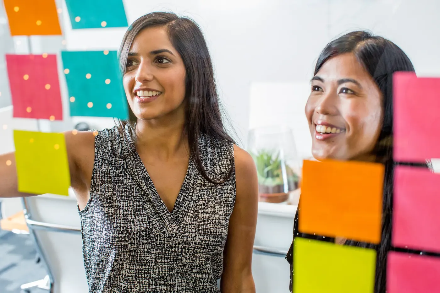 Two women planning a campaign with sticky notes, making sure gambling promotions meet the LCCP marketing rules