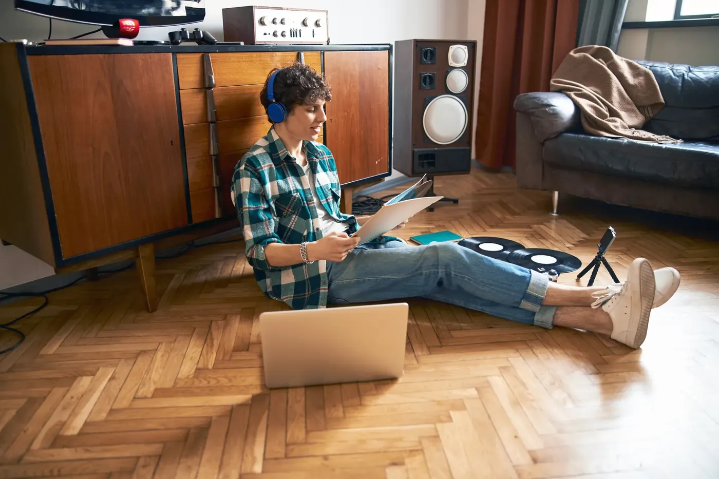 Woman watching content at home with headphones, where AI-generated ads must be labelled under the EU AI Act