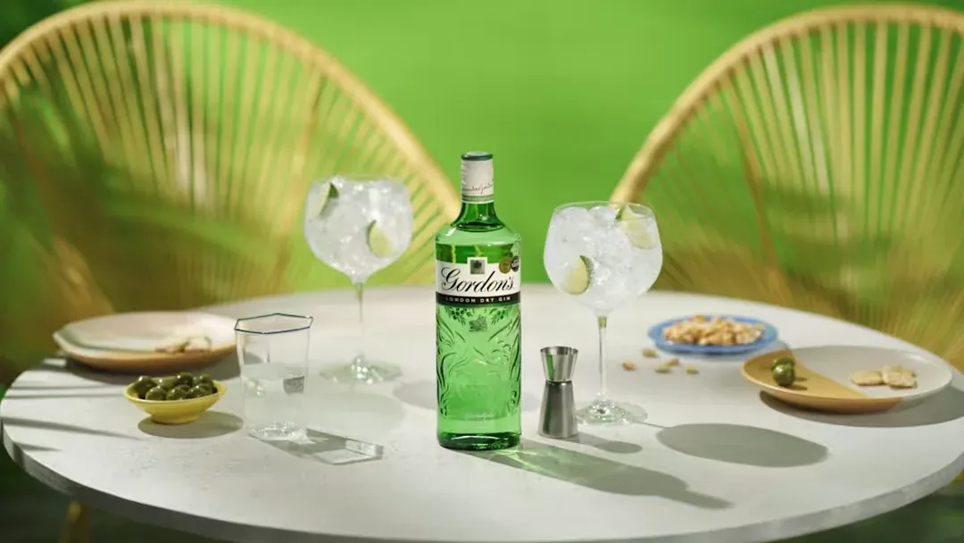 Gin and tonic on a garden table, the kind of drinks ad imagery Voxly Vision checks against the Portman Code and CAP rules