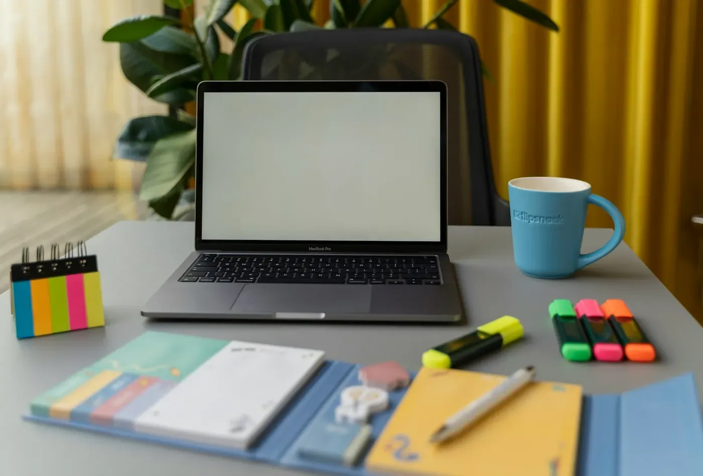 Bright workspace with laptop and sticky notes, where Voxly Vision does the first compliance pass for legal