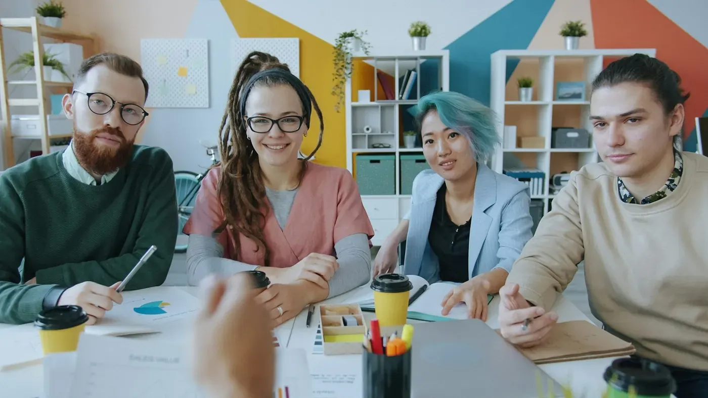 Compliance and marketing team meeting in a colourful office to review ads with Voxly Vision
