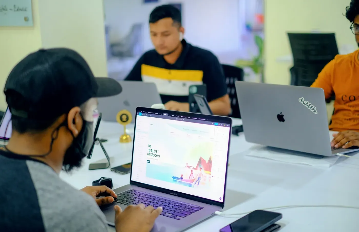 Developer smiling at a laptop after wiring Voxly Vision compliance checks into the build through the API