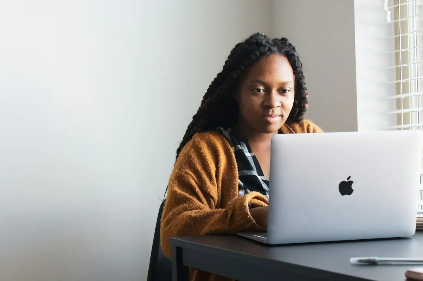 Marketer reviewing a campaign page on her laptop, checking ad compliance with the Voxly Vision Chrome extension