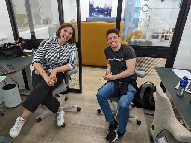 Two Voxly Vision team members working on AI ad compliance software at their desks
