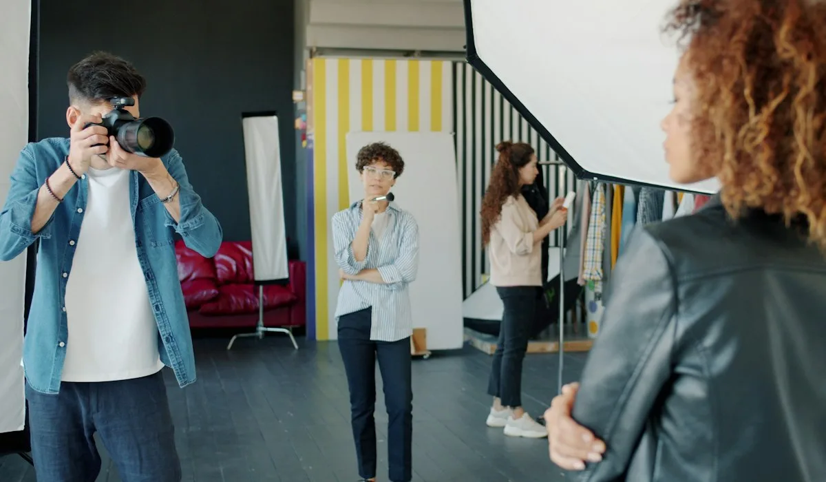 Photographer shooting a model in a bright studio, creating ad content that agencies check with Voxly Vision before sending to the client