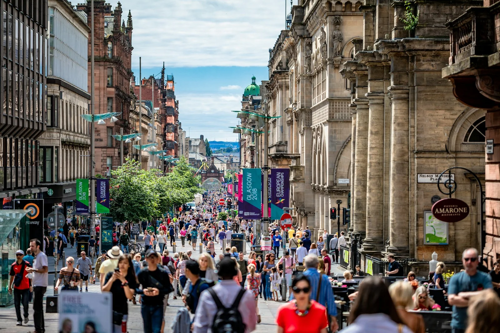 Busy high street on a sunny day, full of shoppers, the everyday places where vape and nicotine ads reach people
