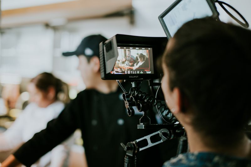 Film crew watching the shot on a monitor during a shoot