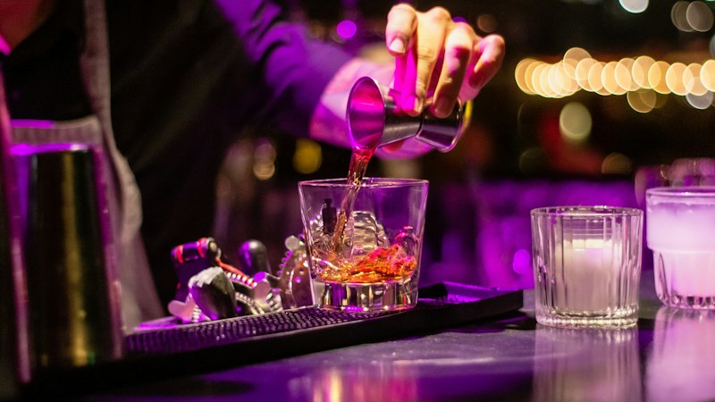 Spirit being poured at a bar, the drinks the Portman Group Code covers