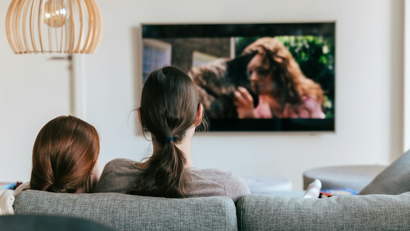 Two people watching TV on the sofa, the broadcast ads the BCAP Code covers