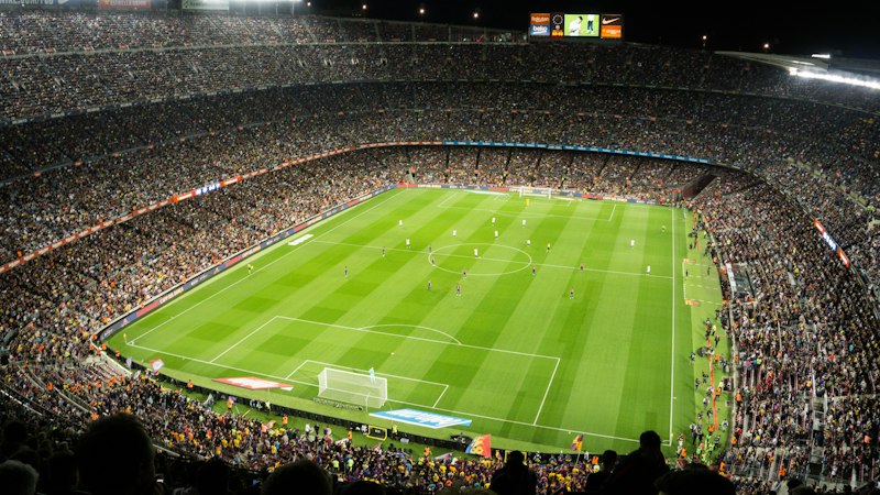 Football crowd in a stadium, where gambling sponsorship and ads reach fans